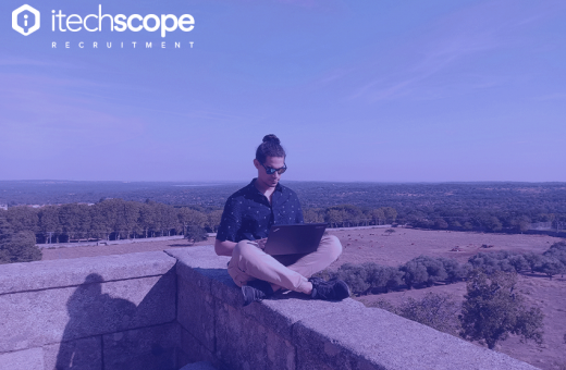 Man sitting with laptop in his lap in nature 