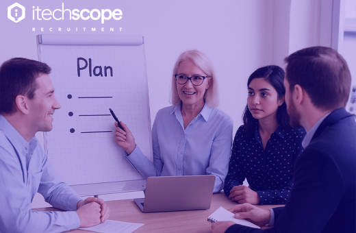 A group of people in front of a whiteboard discussing and learning new things