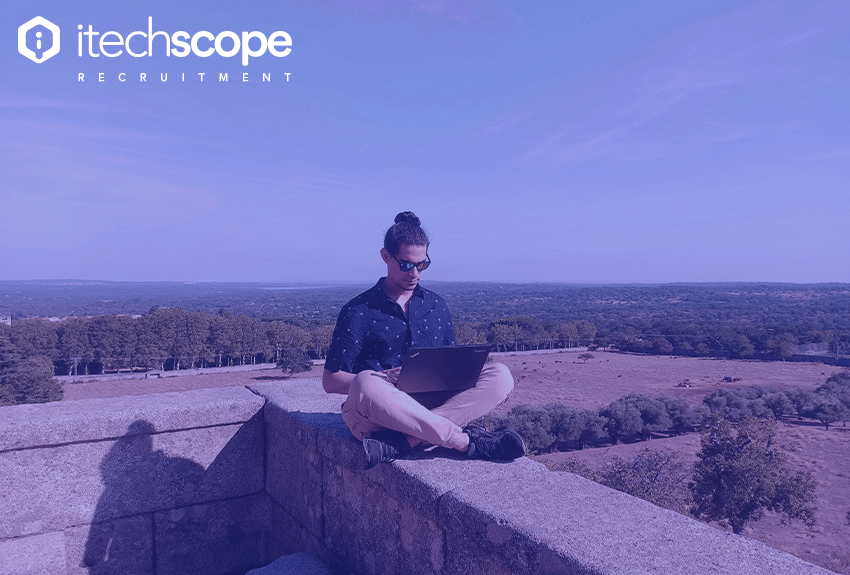 Man sitting with laptop in his lap in nature