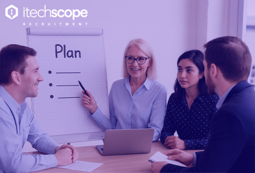 A group of people in front of a whiteboard discussing and learning new things
